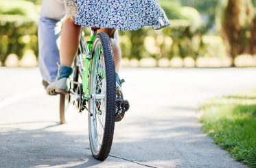 couple with tandem bicycle. lovely couple tandem bicycle riding.